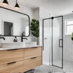 A small modern bathroom with white walls and a black and whitefeat